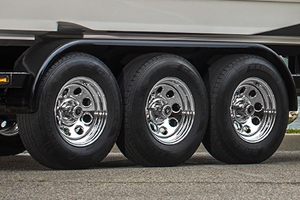 Three tires in a row on a large vehicle